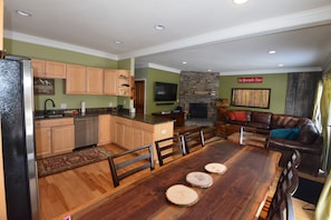 Kitchen with table that seats eight and family room
