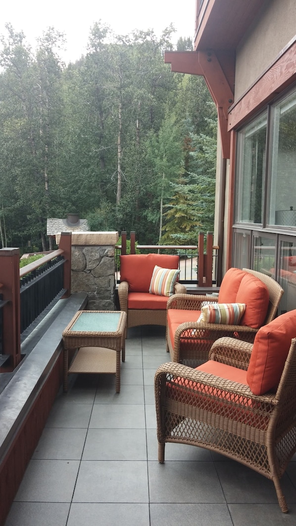 front deck with sitting area and spectacular mountain/slope views and creek