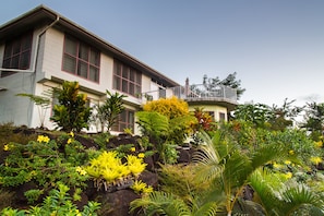 The main house on the hill surrounded by tropical gardens. 