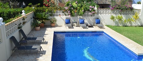 Our spacious heated swimming pool, terrace garden and sun loungers