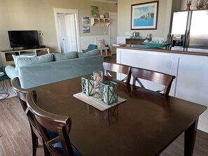 Dining area has plenty of seats and is open to the living area.