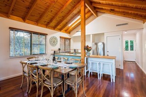 Dine inside around the timber table, with additional seating at the breakfast bar.