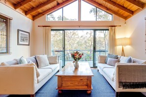 Settle into two plush sofas by the wood-burning fire in the formal living area and soak in breathtaking bushland views.