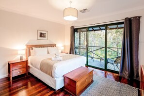 Drift off in the king-sized bed of the primary suite, then step directly onto the expansive deck for a quiet morning coffee or an intimate evening with seating for two amidst nature.