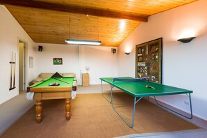 Enjoy hours of fun with billiards, table tennis, and a comfy lounge area.
