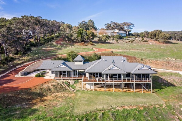 Welcome to Valley Views – a stunning hilltop retreat with panoramic views over Gunyulgup Valley, nestled in complete privacy just minutes from Yallingup and Smiths Beach