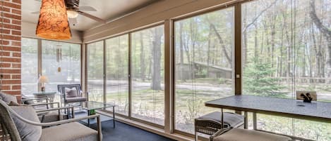 Delightful ~200 sq. ft. screened porch offers dining and relaxed seating options