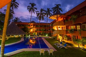 evening view  looking across the pool at the condo