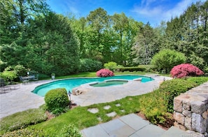 Pool and spa hot tub with waterfall into pool