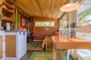 Casita Roja - kitchenette (left), table, and futon