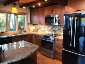 Custom stainless, maple, & granite kitchen- exposed beams- Pine V-groove ceiling