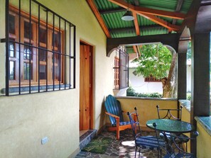 Covered front porch with lake view, table and chairs