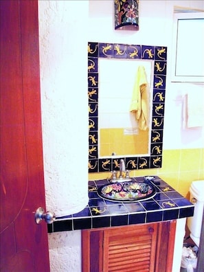 traditional Mexican talavera tile sink and mirror to make you smile