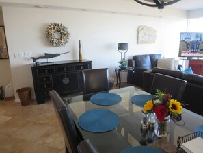 View of dining with large new TV in background