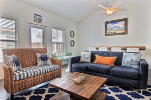 Cozy and bright living room. Back door leads to a private picnic table and hose.