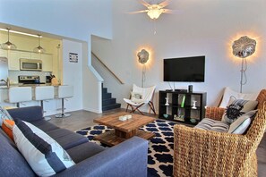 Living room and fully equipped galley kitchen. Granite breakfast bar seats 4.