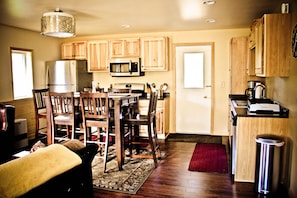 View from the front door, edge of sofa on the left and dining/kitchen area