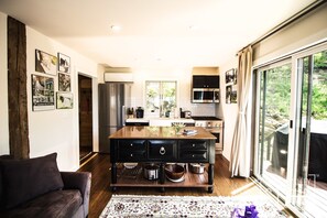 Kitchen with gourmet stove, microwave, refrigerator, and island. 