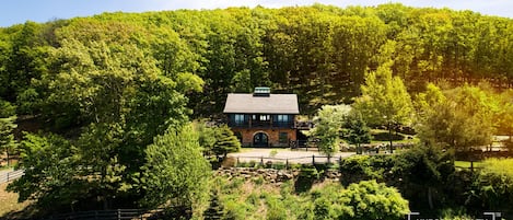 This secluded mountainside estate boasts panoramic Hudson River views.