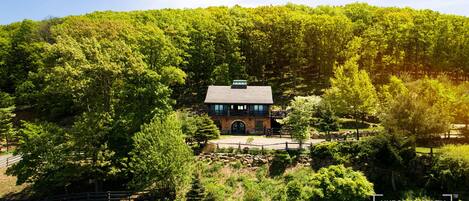 This secluded mountainside estate boasts panoramic Hudson River views.