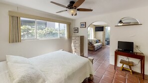 Queen size bed, dresser and small desk with compuiter.