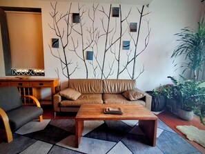 Living room with Scandinavian style sofa and 2 chairs.