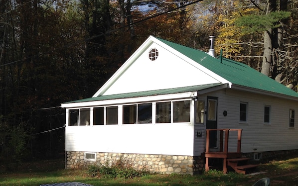 The front of the cabin with porch overlooking the lake