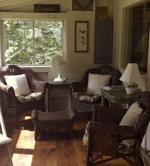 The porch overlooking the lake complete with wicker furniture 