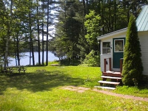 The entry way door to the cabin with view of the lake