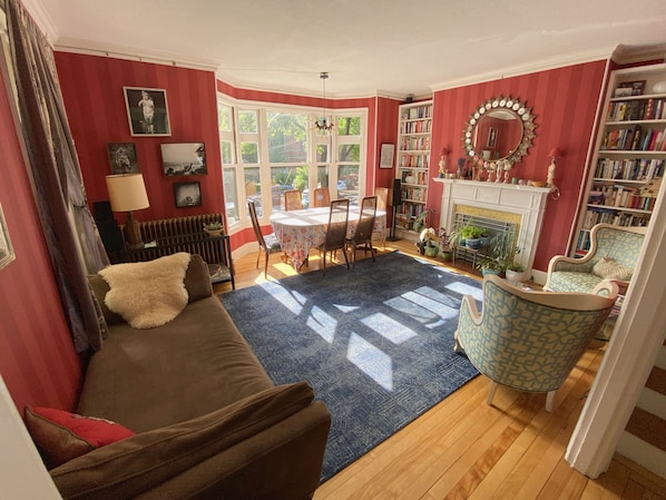 Front living room, light-filled, ready to host meals, a relaxing read, or a nap!