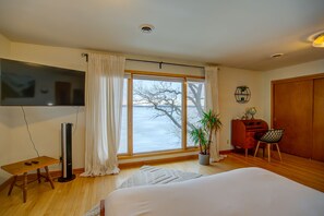 Elevated lake views and workspace in master bedroom.