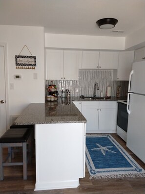 Kitchen and breakfast bar with  dishes, pots/pans, small appliances and spice