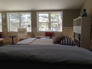 View from bed, looking into living room area and outside