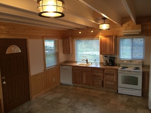 Front door entry and Kitchen. Note the open beam contemporary ceiling!