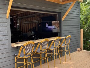 Outdoor deck with bar and TV