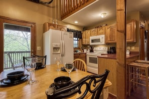 Gatlinburg Cabin "Dances With Wolves" - Dining table and fully furnished kitchen
