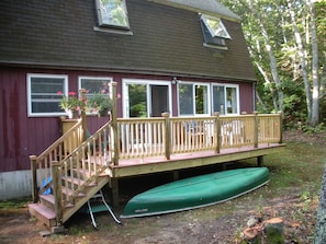 Back view of the cottage with deck and canoe