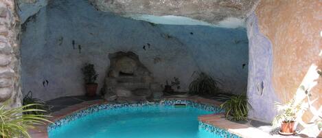 Solar heated pool with integrated jacuzzi, set into a cave!