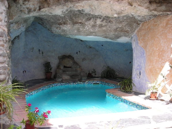 Solar heated pool with integrated jacuzzi, set into a cave!