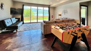 Large downstairs family room - huge 12' slider, foosball table, and plenty of space to relax and hang out