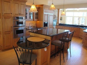 Kitchen island looks at lake and out to woods and pond in front!
