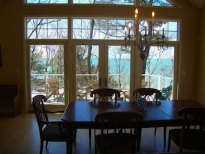Dining room looks out onto wrap around deck and lake view panorama!