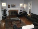 Living room with fireplace looking West and connecting door to kitchen.