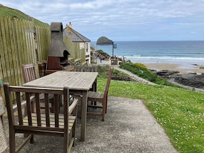 Garden with BBQ, patio furniture and uninterrupted views of sea and Gull Rock.