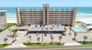 view of property front showing ground and second floor parking, elevators center