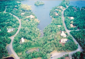 Aerial view of house and lake.