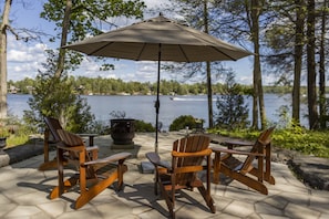 Outdoor stone patio with fire bowl seating off kitchen and bbq