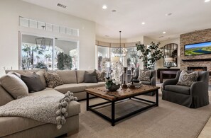 Large, open concept living space with custom furnishings and bright light throughout.