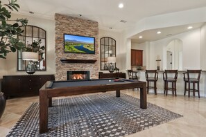 Game room with wet bar, big screen TV and fireplace