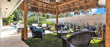 Large Tropical Tiki w/ Plush Furniture, Comfy Turf and Fan at the end of Pool